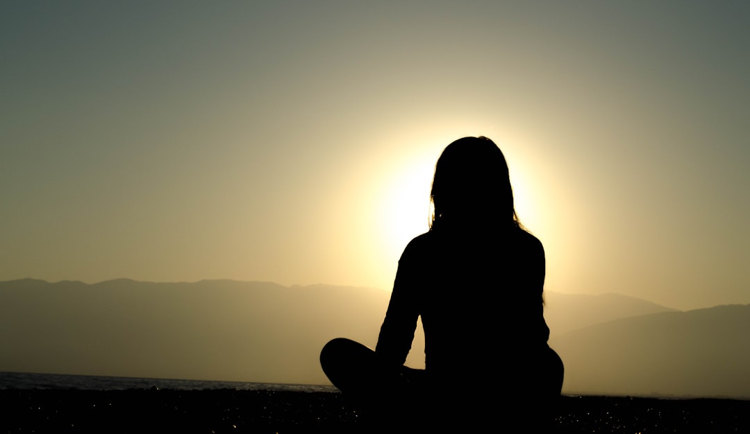 Woman meditating on beach