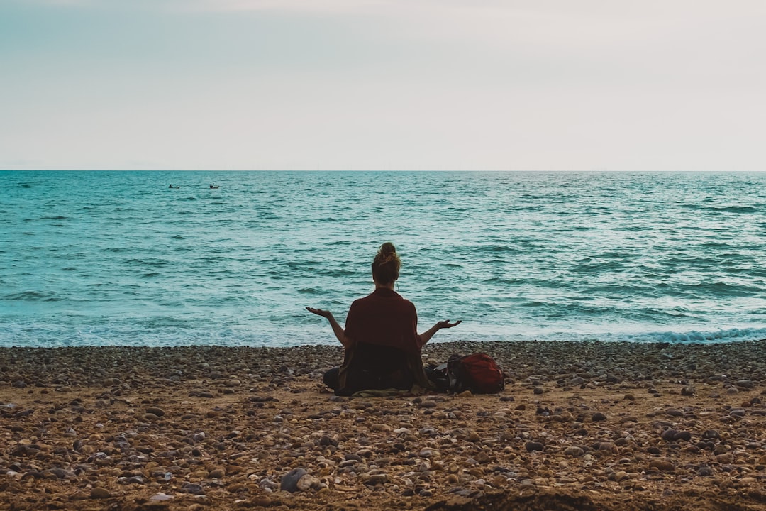 Woman meditating at Brighton beach