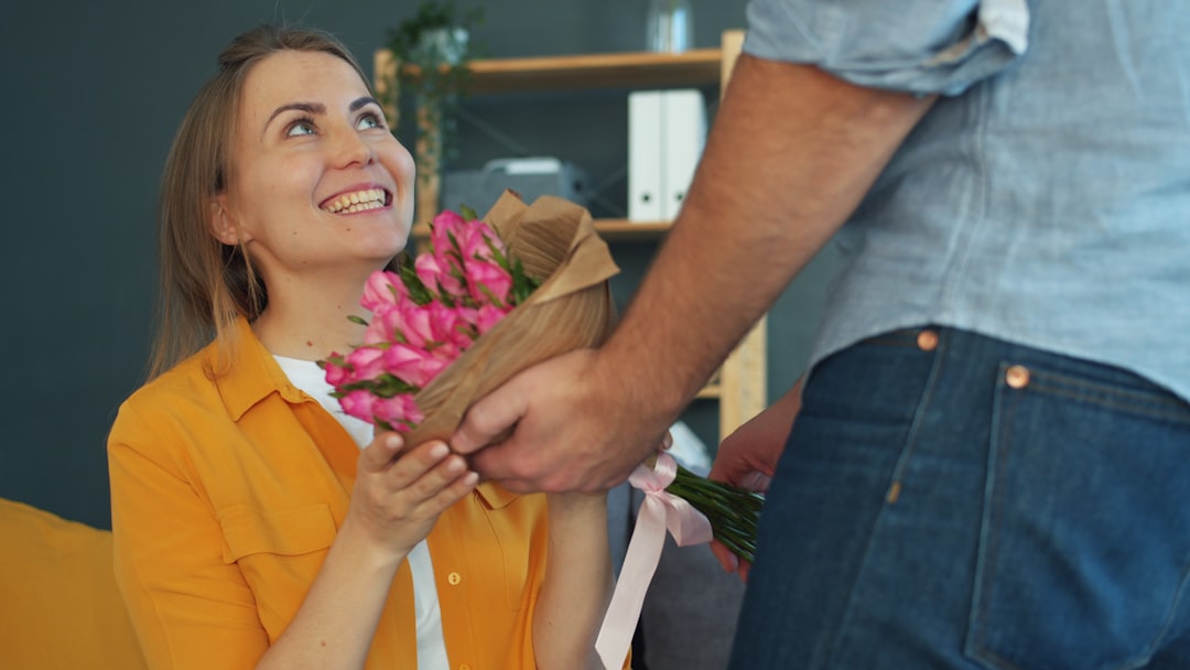 Happy woman receiving surprise flowers