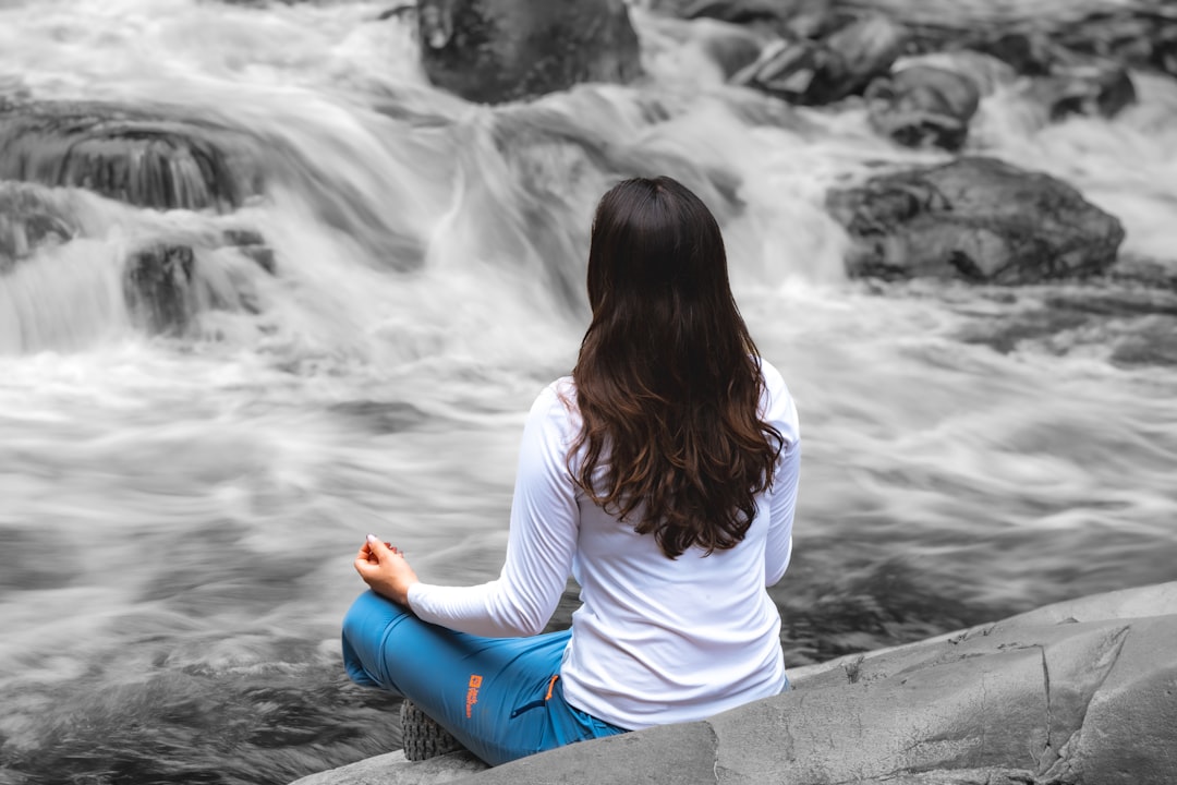 Woman meditating by river