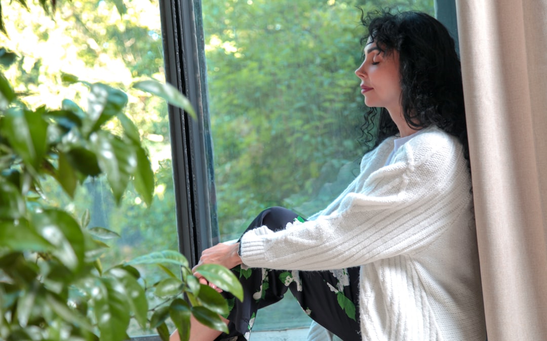 Woman meditating by window