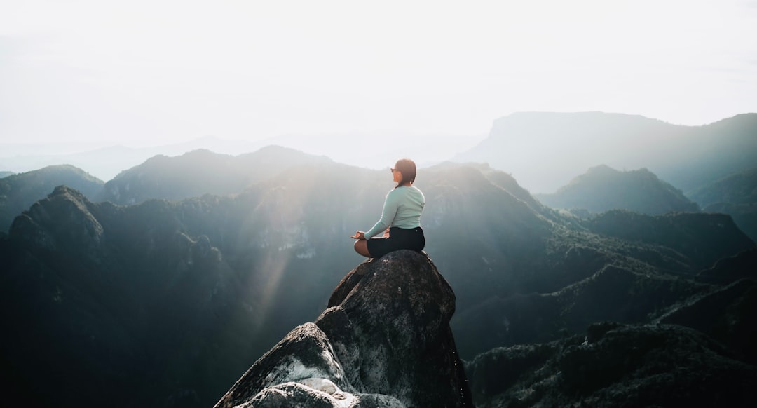 Man meditating on rock